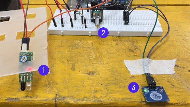 Breadboard circuit with three sensors attached.