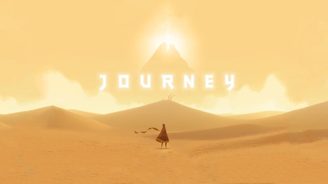 Screenshot from the game 'Journey': lone robed figure walking across sand toward a distant glowing mountain.
